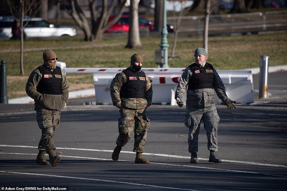 Members of the National Guard are seen patrolling the Capitol grounds on Thursday morning