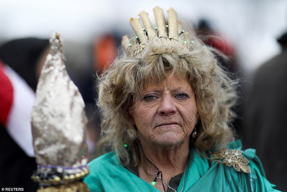 Leigh Ann Luck dressed up as Statue of Liberty poses for a picture as supporters of Donald Trump protested Biden's victory