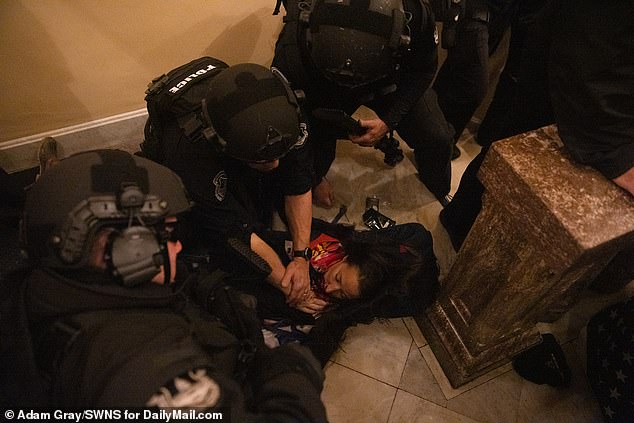 Paramedics tend to Babbitt moments after she was shot inside the Capitol on Wednesday