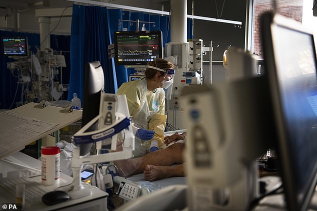 A medic works with a patient in the ICU (Intensive Care Unit) in St George's Hospital in Tooting, south-west London