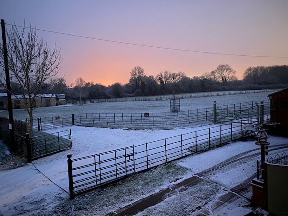 Dawn breaks over a snow-blanketed field in the Cotswolds as most of Britain wakes to snow and ice weather warnings