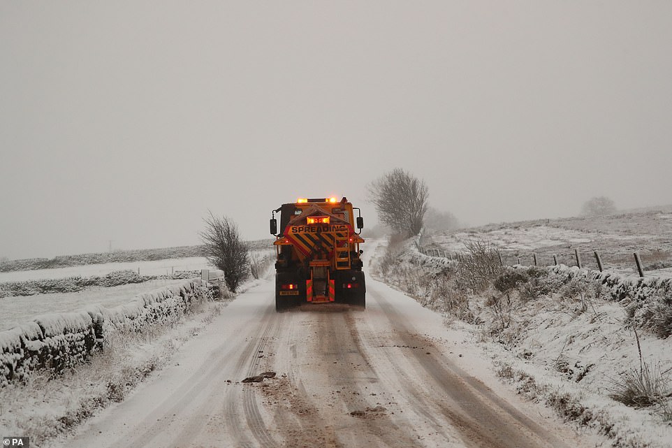 A salt spreader drives down the road in Midhopestones, in the borough of Sheffield