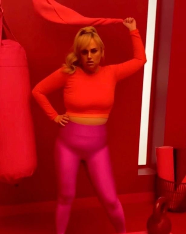 Rebel poses in a red crop top in a social media clip