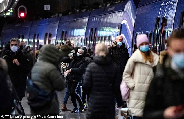 Under the new law, the government will have the authority to close public transport. Pictured: Passengers wearing protective face masks exit a commuter train at Malmo central station in Malmo, Sweden, yesterday