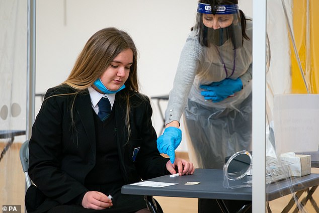 Student Ruby Soden receives instructions on how to self-administer her coronavirus test