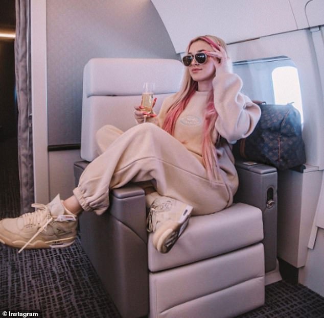 Not so secret: Madi, 16, shared a photo of herself holding a glass of bubbly without a mask on a private jet, tagging TikTok celebrity photographer Bryant Eslava, who was also on the trip