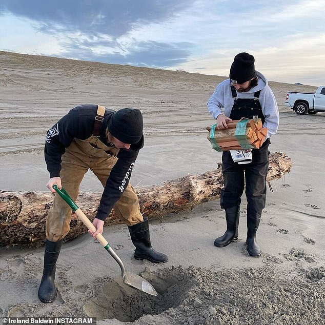 Out with friends: Ireland was joined by her boyfriend, musician Corey Harper, and another friend who held a bundle of firewood