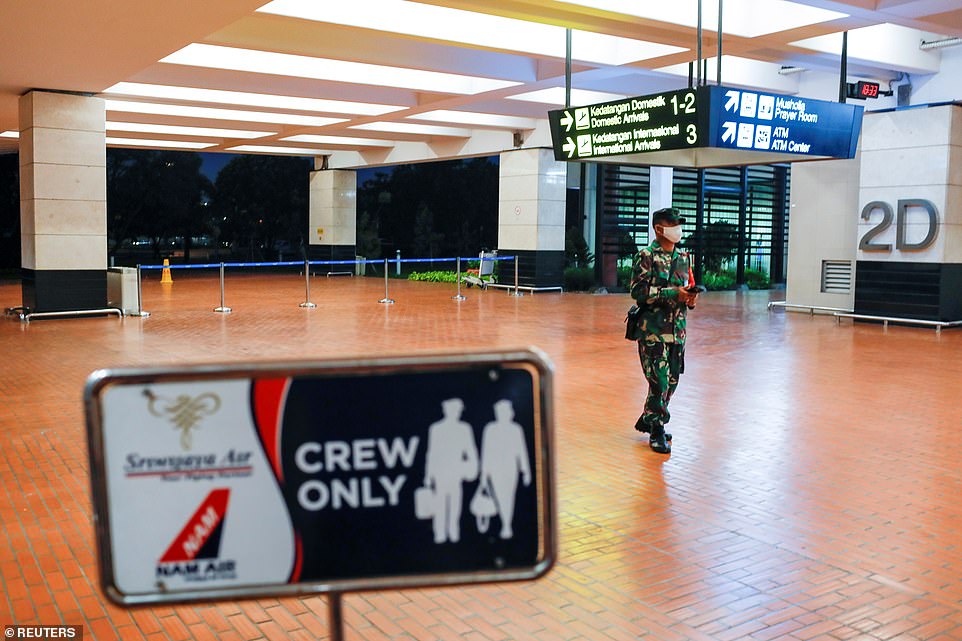 There are feared to be 62 people on the 26-year-old plane, including 56 passengers - seven of whom are children and three are babies - as well as two pilots and four cabin crew. Pictured: Soldiers in Soekarno-Hatta International Airport in Jakarta after the plane lost contact