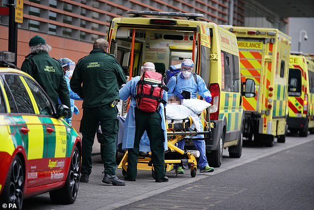 London's mayor Sadiq Khan declared a 'major incident' across the capital in the face of soaring Covid-19 cases. Pictured: Paramedics transfer a patient from an ambulance into the Royal London Hospital on January 8