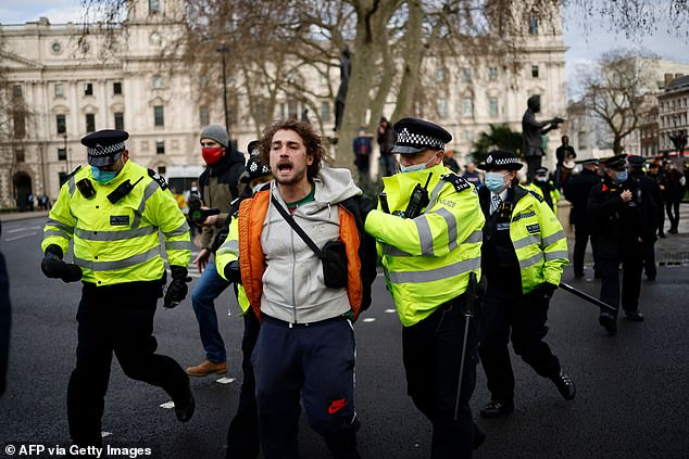 Ameera hit out at anti-lockdown protesters and said none of them will 'ever zip up a body bag in their lives' whilst she and her colleagues are risking their lives every day to treat patients. Pictured: Police officers arrest anti-lockdown protester outside Houses of Parliament in London on 6 January