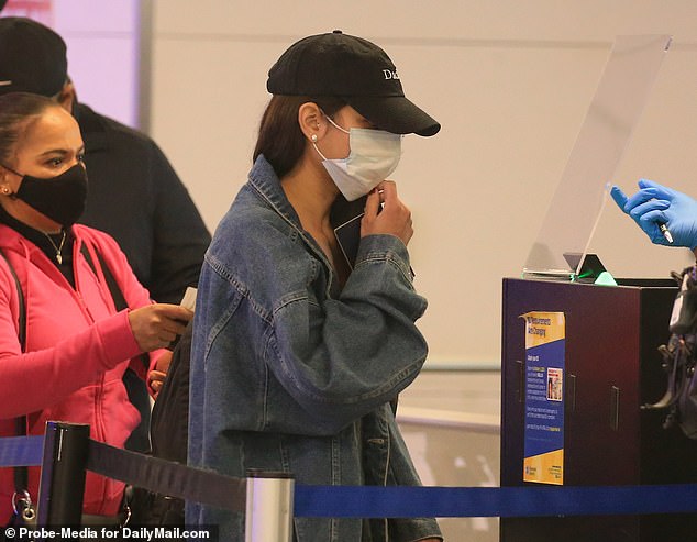 The 22-year-old refused to answer any questions once she arrived at the airport where she was photographed waiting to pass through airport security