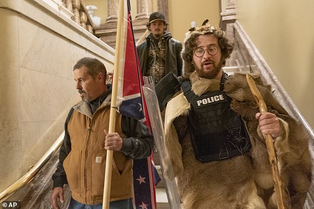 His arrest comes nearly a week after he was pictured walking down the stairs outside the Senate Chamber dressed in fur pelts and a bullet proof vest and carrying a wooden walking stick