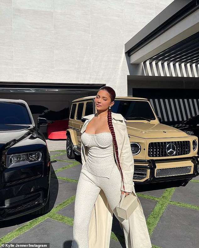 On fleet: Jenner showed off her fleet as she stood in front of a custom Mercedes G-Wagon and a phantom Rolls Royce before arriving in style at Kim's for the final scene