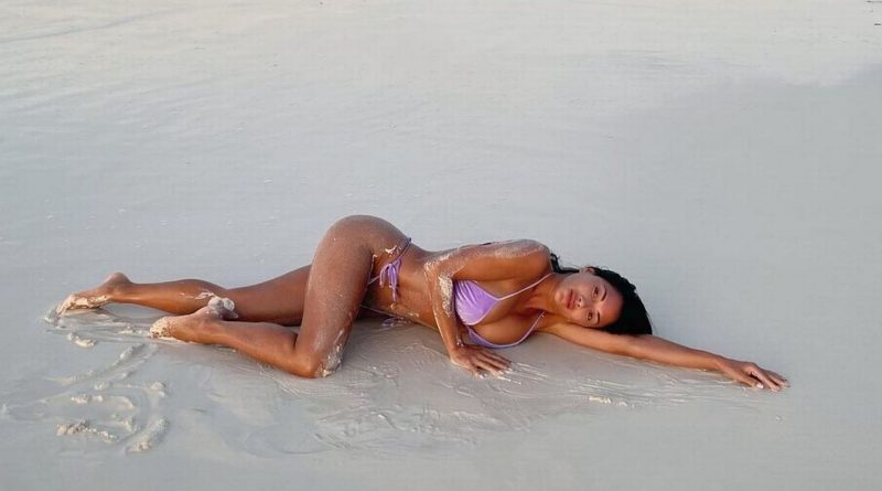 Nicole Scherzinger puts on steamy display as she rolls around on beach in bikini