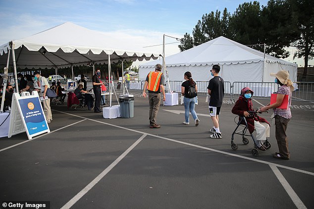 Long lines for vaccines have also formed in California, as pictured above Wednesday