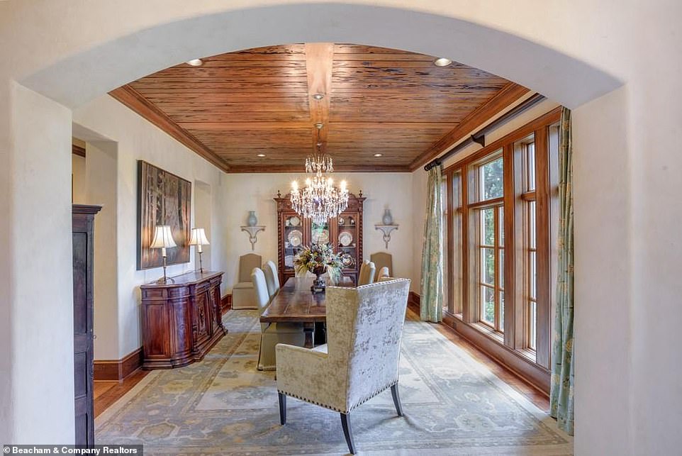 Time to chow down: Another dining room has one long casement window spanning the entirety of one of the walls, so that diners can look out at the expansive estate outside