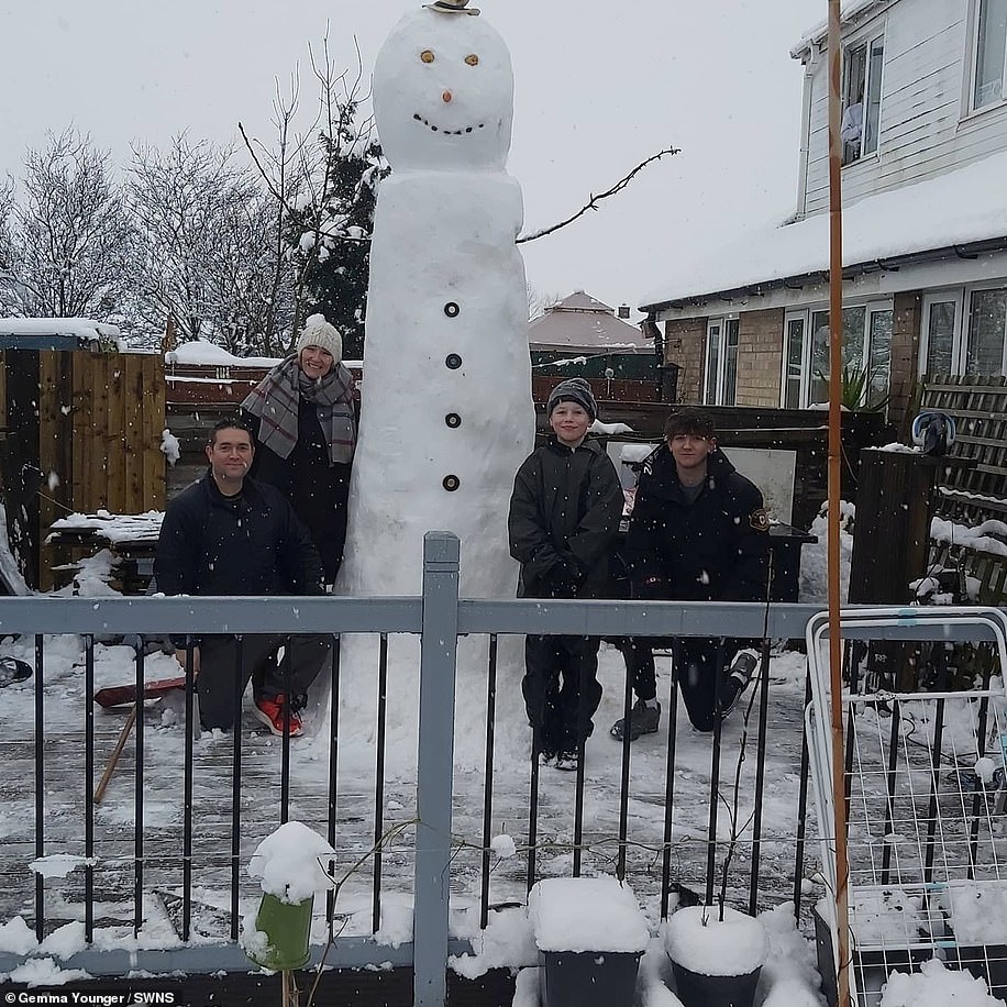 Gemma Younger, 34, and her neighbours spent three hours building the 'tallest snowman' she'd ever seen, in Catterick, North Yorkshire
