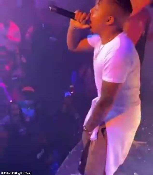 Turn up: The rapper seemed to find nothing wrong with the risky performance as he rapped without a mask and chugged from a bottle of Don Julio 1942