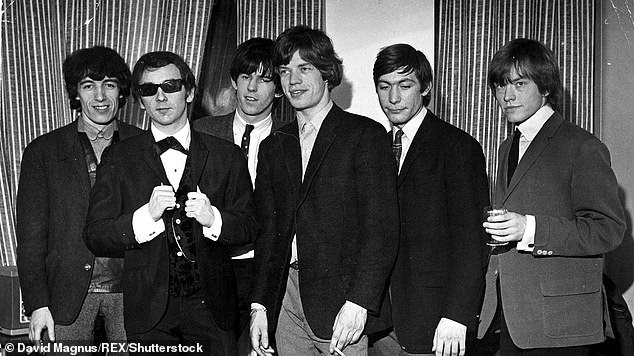 Phil Spector (in sunglasses) pictured with the Rolling Stones