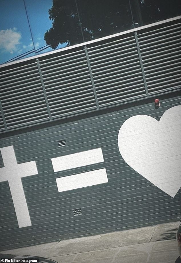 Symbol: The model and actress shared a photo to Instagram of a cross equals love symbol, at the front of a Hillsong Church
