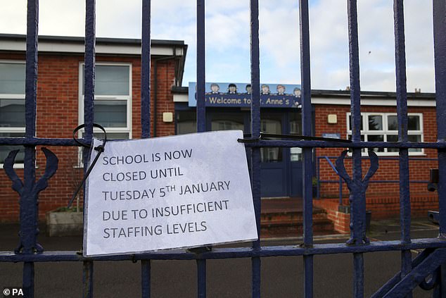 A sign hangs on the gate of St Anne's Catholic Primary school in Caversham, Reading