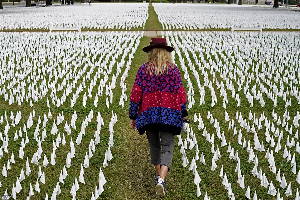 The first known deaths from the virus in the U.S. were in early February 2020, both of them in Santa Clara County, California. Pictured: Artist Suzanne Brennan Firstenberg walks among thousands of white flags planted in remembrance of Americans who have died of COVID-19 near Robert F. Kennedy Memorial Stadium in Washington, October 2020