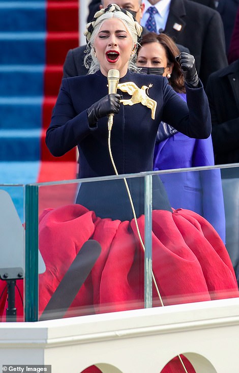 Red, white and blue: Gaga's frock was expertly tailored, anchoring her 5foot2 figure with navy blue bodice with long sleeves, sturdy shoulders and a tapered waist