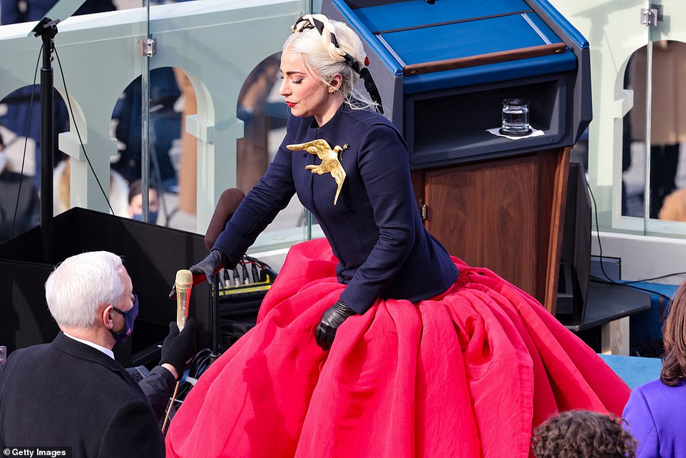 Helping hand: The star's dress was so dramatic she needed some help getting down the stairs