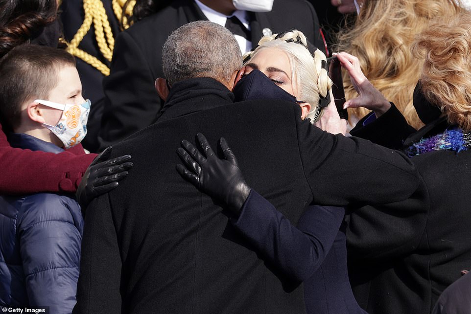 Lady Gaga hugs former President Barack Obama after the inauguration of US President Joe Biden at the Capitol