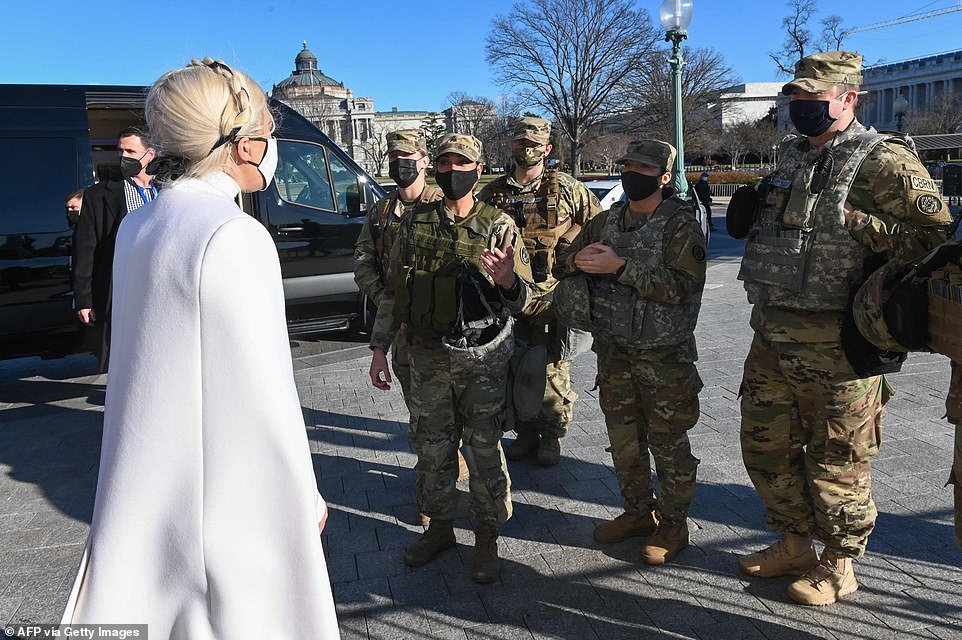 Lady Gaga greets National Guard soldiers Tuesday as she leaves the US Capitol after rehearsing for Wednesday's inauguration