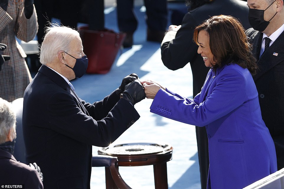 Incredible bond: Harris had a bright smile on her face as she and Biden bumped fists during the inauguration