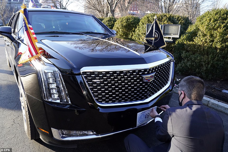 A US Secret Service agent changes the license plate on President Joe Biden's limousine near the North Portico of the White House