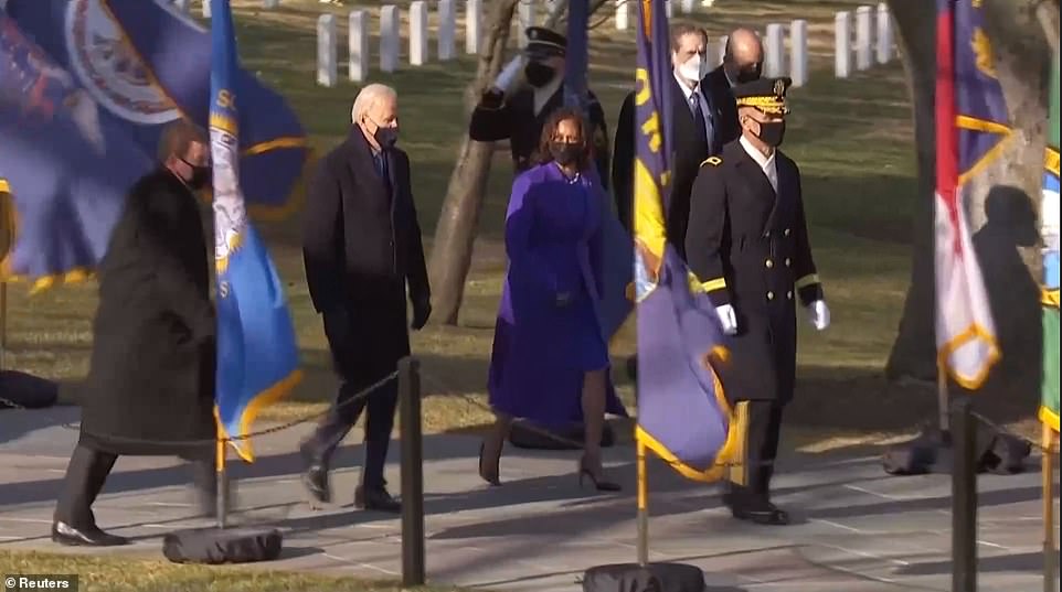 President Joe Biden and Vice President Kamala Harris walk to the Tomb of the Unknown Soldier in Arlington National Cemetery Wednesday