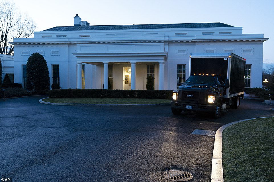 A moving truck drives away from the West Wing of the White House, Wednesday, Jan. 20, 2021, in Washington, on Wednesday January 20