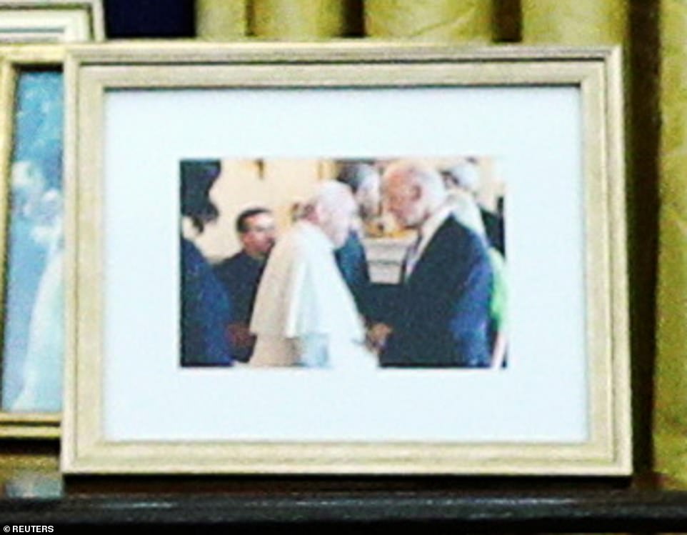 Biden has already added some personal touches to the Oval Office. A picture with the Pope sits behind him. Biden will be the nation's second Catholic president