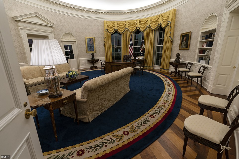 Biden brought a dark blue rug out of storage to replace a lighter colored one installed by Donald Trump. Also gone are Trump's gold curtains, replaced with darker shade that hung when Bill Clinton was president