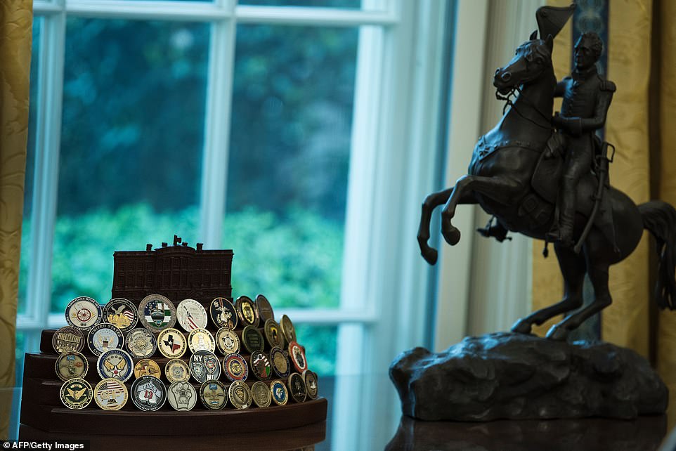 A collection of US President Donald Trump's challenge coins are seen in the Oval Office of the White House April 24, 2017