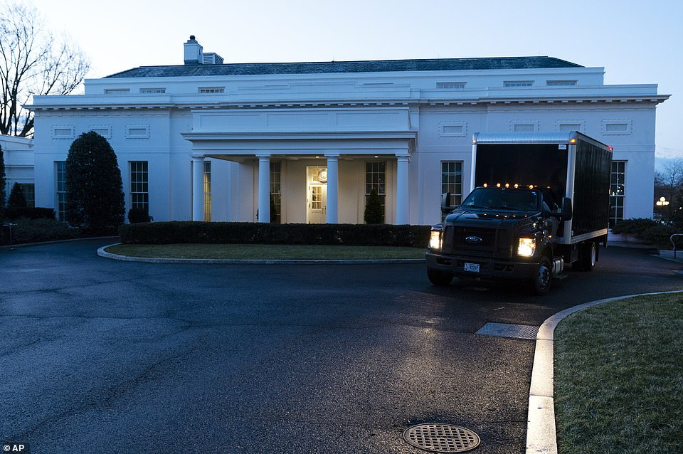 A moving truck drives away from the West Wing of the White House, Wednesday, Jan. 20, 2021, in Washington, on Wednesday January 20