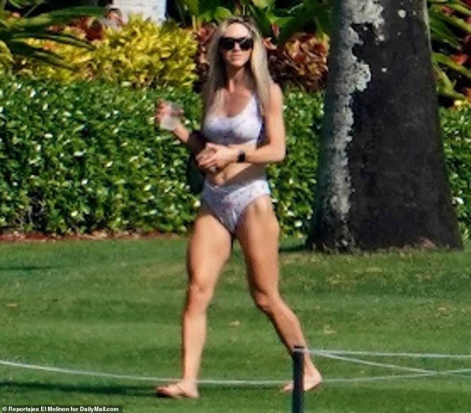 Out of office! Mother-of-one Lara was also seen carrying a drink in her hand as she made her way across the sprawling property, where she and the Trump family are hunkering down in the wake of Donald's presidency coming to an end