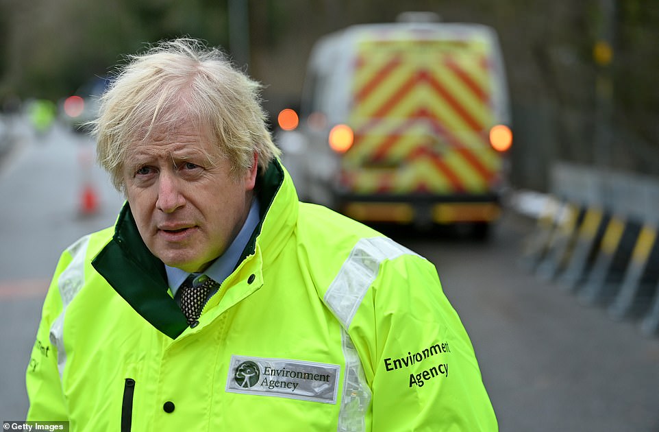 Prime Minister Boris Johnson visits a storm basin near the River Mersey in Didsbury on January 21, 2021 in Manchester, England
