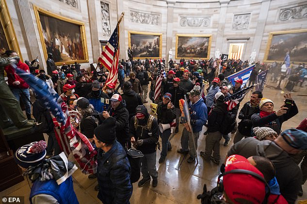 Trump supporters march through the Capitol Rotunda during the January 6 invasion of Congress. Fisher's lawyer says there is no evidence he made it inside the Capitol