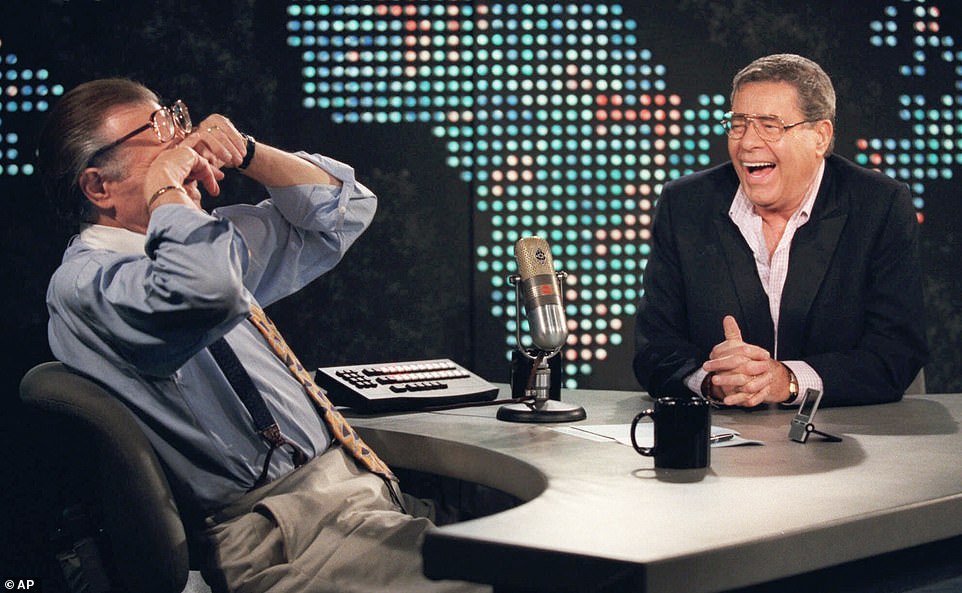 In this Thursday, August 26, 1999, file photo, King wipes his eyes after laughing at a joke by comedy legend Jerry Lewis, on the set of Larry King Live at CNN Studios in the Hollywood section of Los Angeles