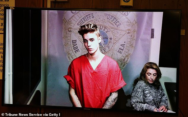 Plea deal: The Love Yourself songwriter would go on to plead guilty to resisting an officer without violence in addition to driving without due care and attention; he is pictured during his bond hearing from 2014