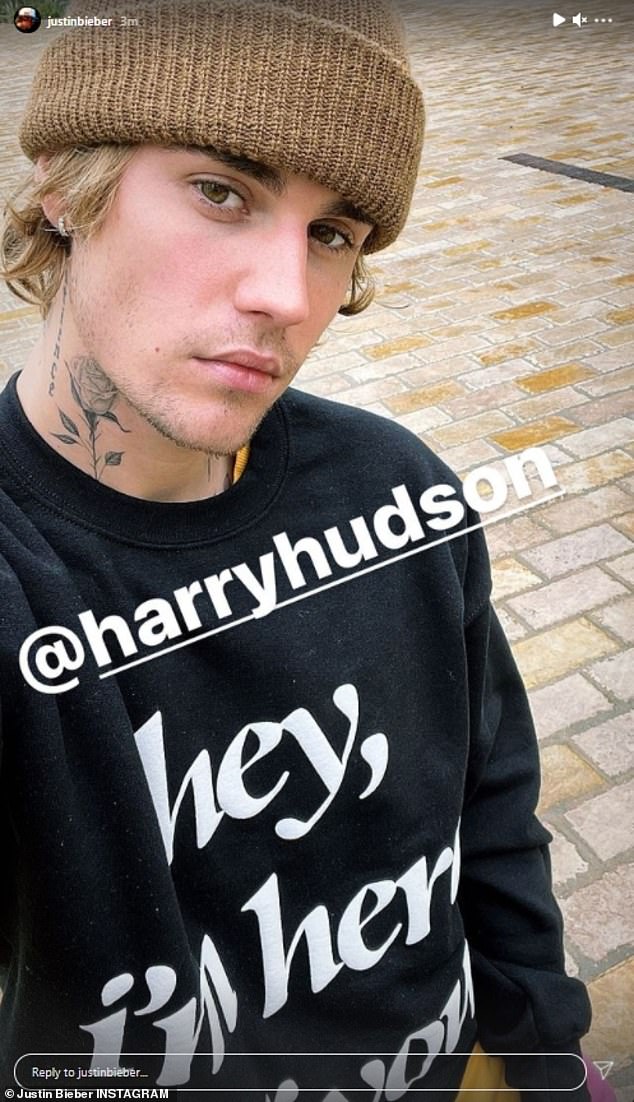 Staying cozy: Before sharing the arrest photo, the Sorry songwriter posted a selfie wearing a large beanie and a black crewneck sweater