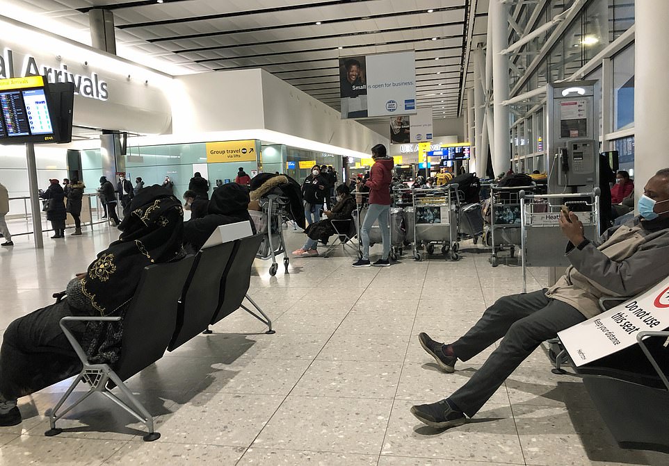 Passengers wait at  Heathrow Airport yesterday as ministers mull even tighter rules