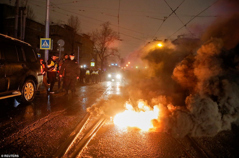 A smoke bomb lies on the street as protesters were detained during rally in support of jailed Russian opposition leader Alexei Navalny, near Matrosskaya Tishina prison, in Moscow