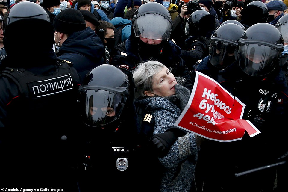 Police take a protester into custody during a protest demanding the release of Russian opposition leader Alexei Navalny in Moscow