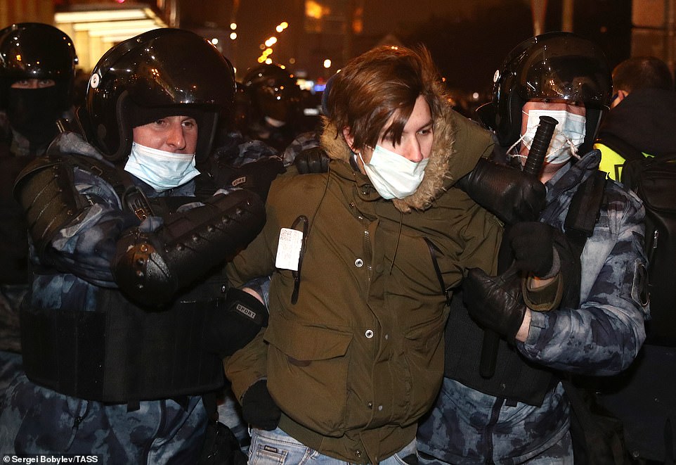 Riot police officers detain a participant in an unauthorized rally in support of Russian opposition activist Alexei Navalny in Tverskaya Street