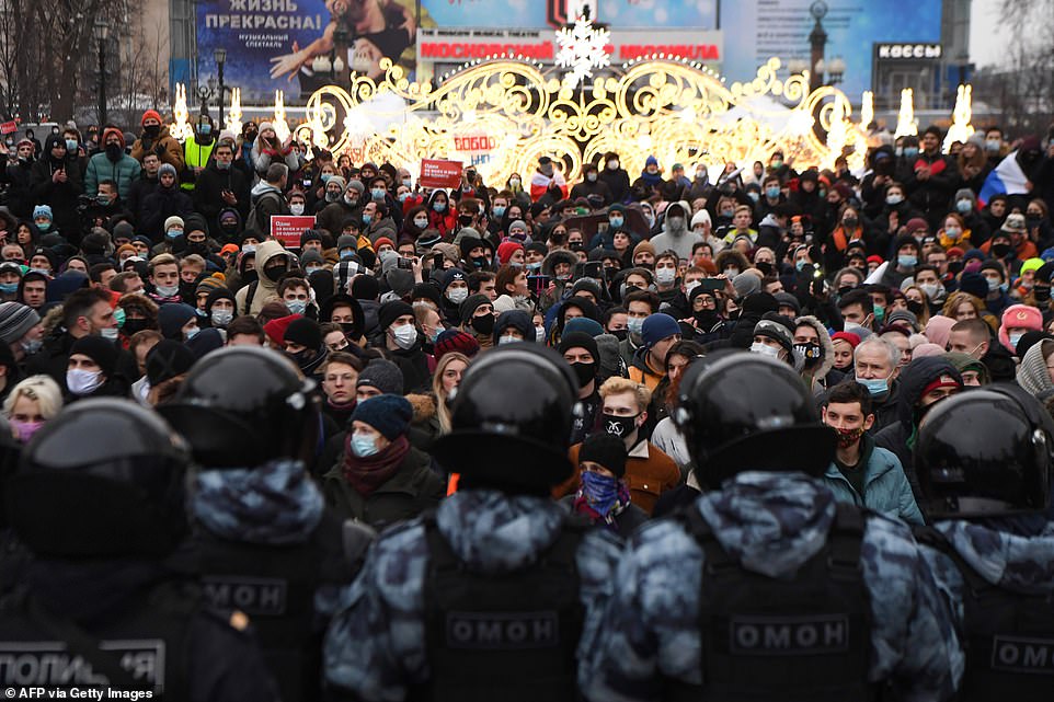 Some protesters chanted 'Putin is a thief', and 'Disgrace' and 'Freedom to Navalny!' Pictured: People face off against police at a rally in support of jailed opposition leader Alexei Navalny in downtown Moscow on January 23