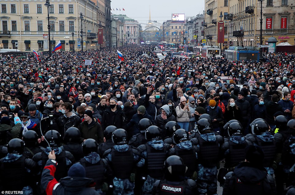 Law enforcement officers stand in front of participants during a rally in support of jailed Russian opposition leader Alexei Navalny in Saint Petersburg, Russia January 23